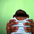 A 4-month-old baby born with microcephaly is held by his mother in front of their house in Olinda, near Recife, Brazil, February 11, 2016.