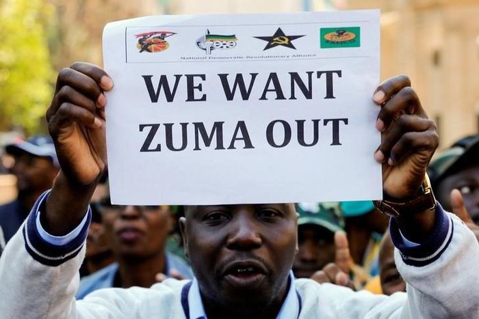 A member of a group planning to stage an ‘Occupy’ protest outside the ANC headquarters demanding South African President Jacob Zuma and other senior party officials to resign, holds a placard in downtown Johannesburg, South Africa, September 5, 2016.