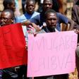 Opposition party supporters hold placards during a court appearance of those arrested following Friday's protest march, in Harare, Zimbabwe, August 29, 2016.