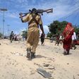 A Somali policeman walks towards the scene of an explosion outside the headquarters of Somalia's Criminal Investigation Department (CID) in the capital Mogadishu, July 31, 2016.