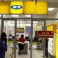 A man speaks on a mobile phone as he walks past a MTN shop at a shopping mall south of Johannesburg June 6, 2012.
