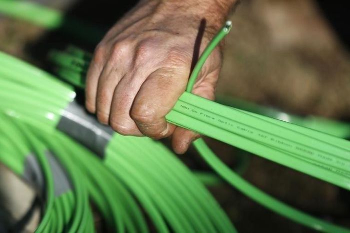 A NBN Co worker arranges fibre-optic cables used in the National Broadband Network in west Sydney July 11, 2013. REUTERS/Daniel Munoz
