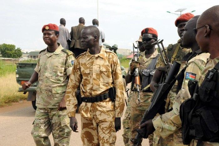 South Sudan National security members stand guard as they protect internally displaced people during a reallocation at the United Nations Mission in South Sudan (UNMISS) compound at the UN House in Jebel, in South Sudan's capital Juba, August 31, 2016....
