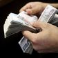 A customer counts his Egyptian 50 pound notes at an exchange office in downtown Cairo, Egypt, April 19, 2016. REUTERS/Amr Abdallah Dalsh