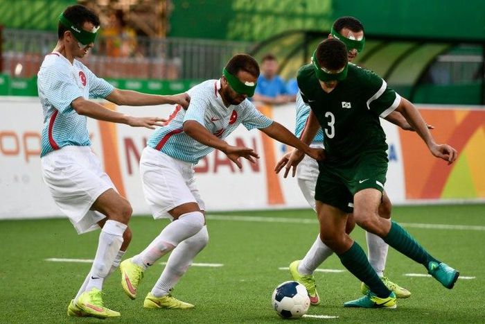 Brazilian Cassio (R) struggles for the ball during the football 5-a-side match against Turkey during the Rio 2016 Paralympic Games