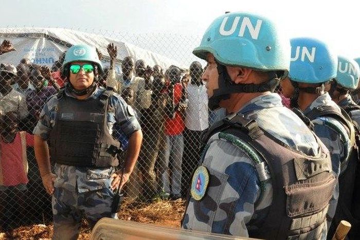 U.N. peacekeepers stand guard at a demonstration by people displaced in the recent fighting, during a visit by the United Nations Security Council, delegation to the UN House in Jebel, near South Sudan's capital Juba, September 3, 2016.