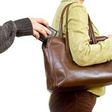 A man picking a woman's purse