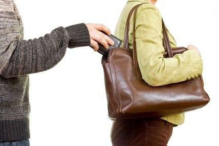 A man picking a woman's purse