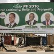 People walk by a billboard with picture of the incumbent president Edgar Lungu, of the Patriotic Front ruling Party, two days ahead of Zambian Presidential and legislative elections on August 9, 2016