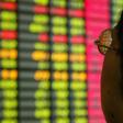 A Chinese investor monitors share prices at a securities company in Shanghai, file.