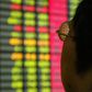 A Chinese investor monitors share prices at a securities company in Shanghai, file.