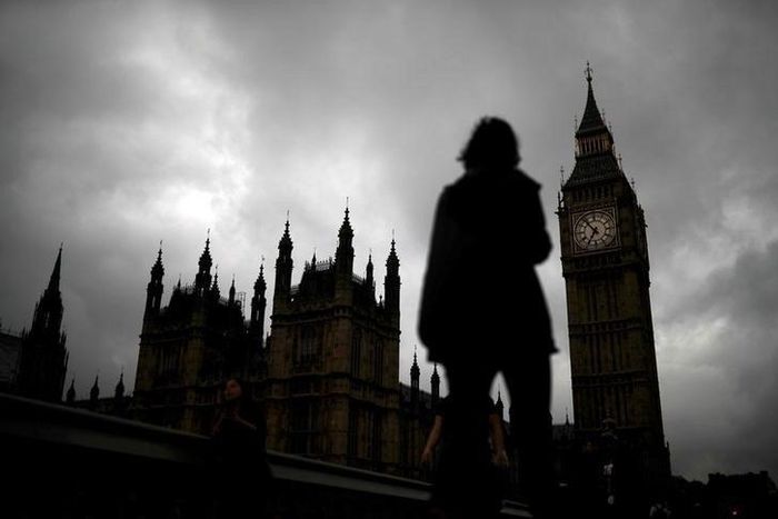 A woman walks past the Houses of Parliament and the Big Ben clock tower, on the day of the EU referendum, in central London, Britain June 23, 2016.
