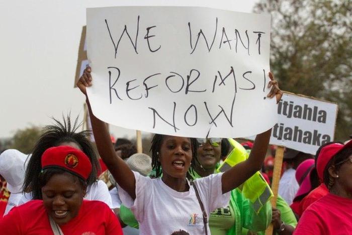 A protester holds a placard as Zimbabwe opposition supporters under the National Electoral Reform (NERA) coalition march through the streets of Bulawayo, on September 17, 2016