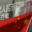 China's national flag is seen in front of a poster explaining the design of new 100 yuan banknote at a branch of a commercial bank at a business district in Beijing, China, January 21, 2016.