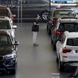 A man takes a look at BMW cars at a dealer shop in Beijing, China, September 11, 2015.    REUTERS/Kim Kyung-Hoon