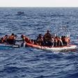 An inflatable boat from the Spanish vessel Astral operated by the NGO Proactiva collects migrants off the Libyan coast in the Mediterranean Sea August 18, 2016.