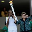Brazil's President Dilma Rousseff (R) waves after lighting a cauldron with the Olympic Flame next to Fabiana Claudino, captain of the Brazilian volleyball team, during the Olympic Flame torch relay at Planalto Palace in Brasilia, Brazil, May 3, 2016. R...
