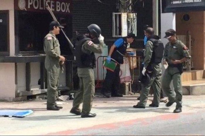 Officials investigate at the scene of bomb blasts in the tourist beach town of Patong on Phuket island, Thailand in this still image from video August 12, 2016.