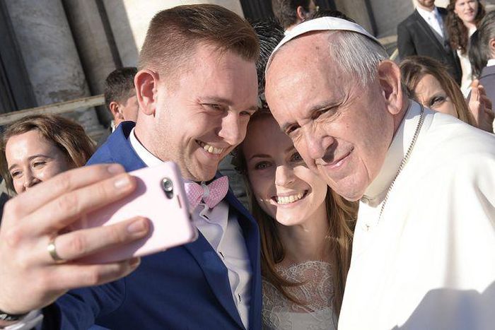 Pope Francis with a newly married couple