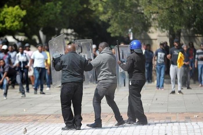 Students throw stones during clashes with security at Johannesburg's University of the Witwatersrand as countrywide protests demanding free tertiary education entered a third week, South Africa, September 20, 2016.