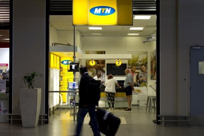 Travellers walk past an MTN telecom shop at King Shaka International Airport in Durban, South Africa, in a file photo. REUTERS/Rogan Ward