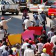 Locals hold placards during a protest by opposition youths who were demonstrating against alleged brutality by security agents in the capital Harare, Zimbabwe August 24, 2016.