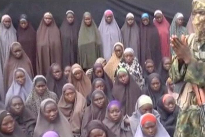 A still image from a video posted by Nigerian Islamist militant group Boko Haram on social media, seen by Reuters on August 14, 2016, shows a masked man talking to dozens of girls the group said are school girls kidnapped in the town of Chibok in 2014....