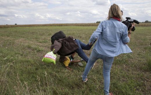 Hungary charges camerawoman accused of tripping fleeing migrants