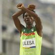 2016 Rio Olympics - Athletics - Final - Men's Marathon - Sambodromo - Rio de Janeiro, Brazil - 21/08/2016. Feyisa Lilesa (ETH) of Ethiopia celebrates.