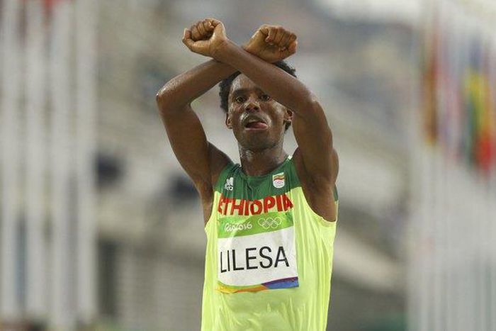 2016 Rio Olympics - Athletics - Final - Men's Marathon - Sambodromo - Rio de Janeiro, Brazil - 21/08/2016. Feyisa Lilesa (ETH) of Ethiopia celebrates.
