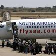 Passengers board a South African Airways Boeing 737 aircraft at the Kamuzu International Airport in Lilongwe  in a file photo.
  REUTERS/Siphiwe Sibeko