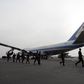 Rwandan troops who have returned from the Sudan's Darfur region walk past the U.S. Air Force One at Kigali International airport, file.