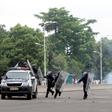 Congolese policemen run to their vehicle during a clash with opposition activists participating in a march to press President Joseph Kabila to step down in the Democratic Republic of Congo's capital Kinshasa, September 19, 2016.