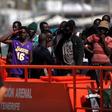 Migrants, who are part of a group intercepted aboard a dinghy off the coast of the Mediterranean sea, stand on a rescue boat upon arriving at a port in Malaga, southern Spain, September 6, 2016.
