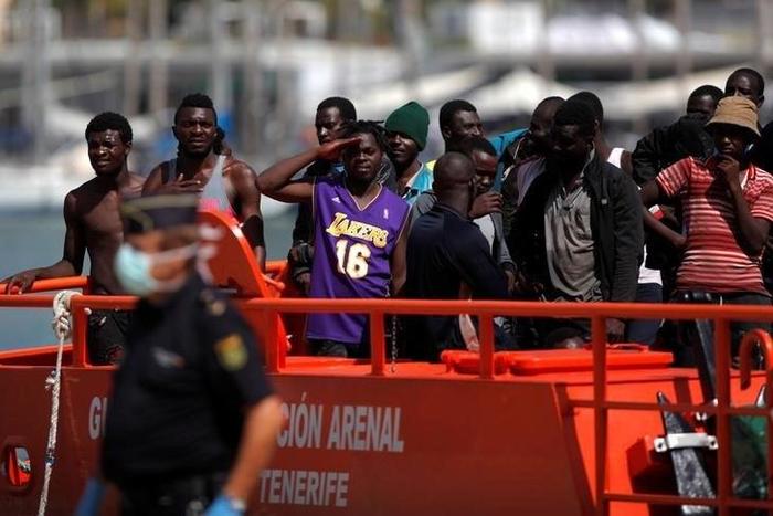 Migrants, who are part of a group intercepted aboard a dinghy off the coast of the Mediterranean sea, stand on a rescue boat upon arriving at a port in Malaga, southern Spain, September 6, 2016.