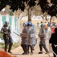 Police officers look on during a protest by opposition party supporters in Harare, Zimbabwe, August 26,2016.