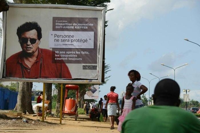 French-Canadian journalist Guy-Andre Kieffer pictured on the billboard was last seen in a car park in Abidjan in April 2004 with Michel Legre