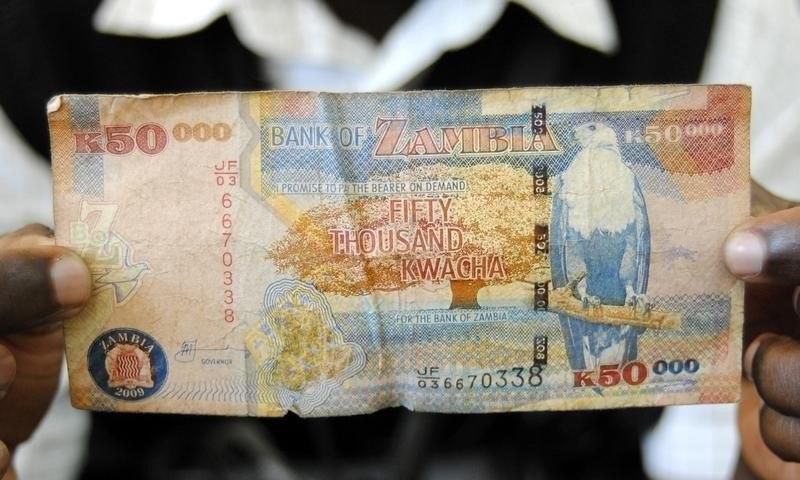 A man displays a 50,000 Kwacha note in Lusaka January 23, 2012. REUTERS/Mackson Wasamunu