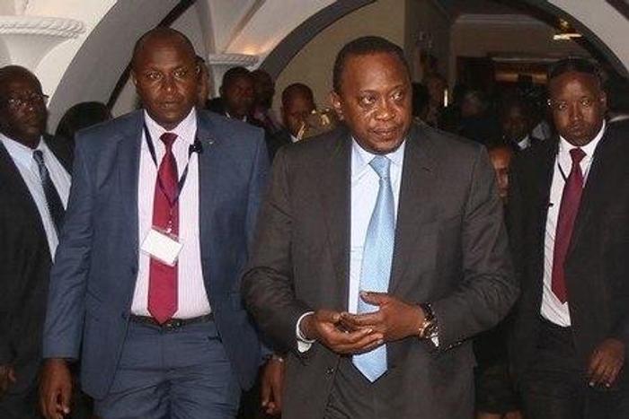 Kenyan President Uhuru Kenyatta is escorted from the meeting hall during the Intergovernmental Authority on Development (IGAD) extraordinary summit on South Sudan in Ethiopia's capital Addis Ababa, August 5, 2016.