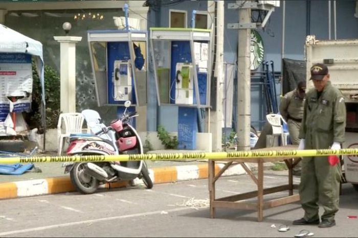 Police Explosive Ordnance Disposal (EOD) official inspects the site of a bomb blast in Hua Hin, south of Bangkok, Thailand, in this still image taken from video August 12, 2016.