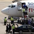 Passengers board a South African Airways Boeing 737 aircraft at the Kamuzu International Airport in Lilongwe, file.