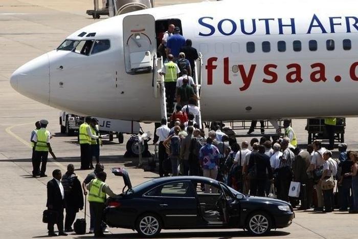 Passengers board a South African Airways Boeing 737 aircraft at the Kamuzu International Airport in Lilongwe, file.