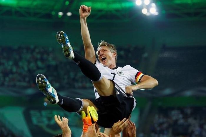 Germany's Bastian Schweinsteiger is honoured after the match.