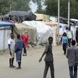 Migrants walk in the northern area of the camp called the "Jungle" in Calais, France, September 6, 2016.