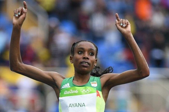 Ethiopia's Almaz Ayana celebrates as she crosses the finish line to win the women's 10,000m during the 2016 Olympic Games in Rio de Janeiro 