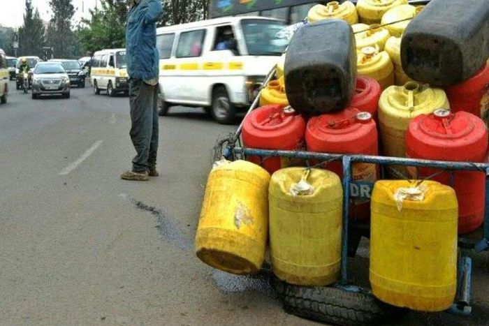 A man hawks water in jerry cans in Nairobi on August 31, 2015 