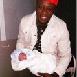 Chuddy K with his new born baby daughter