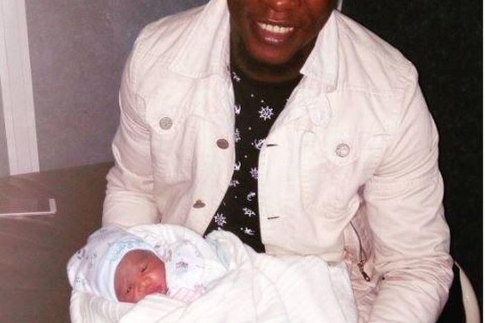 Chuddy K with his new born baby daughter