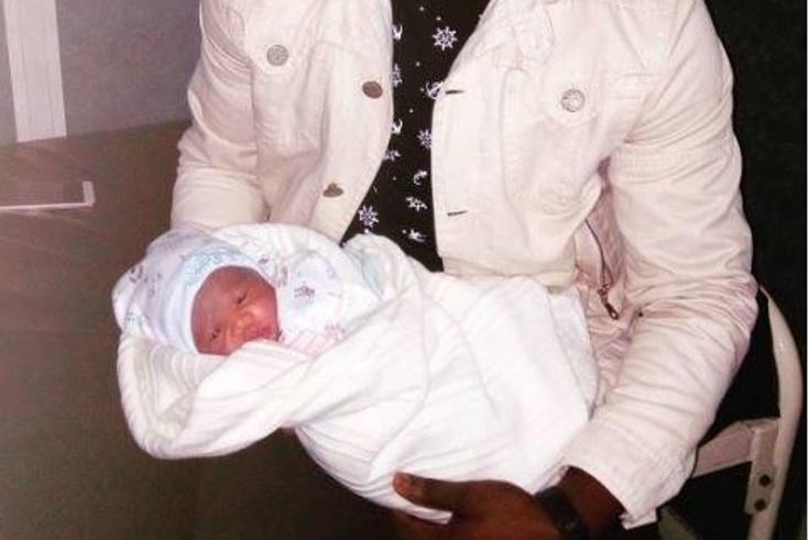 Chuddy K with his new born baby daughter