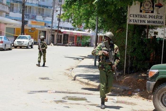 Armed policemen walk outside the central police station after an attack, in the coastal city of Mombasa, Kenya, September 11, 2016.